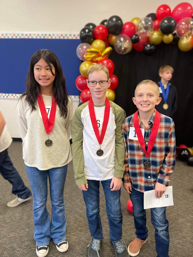 Three Students wearing medals
