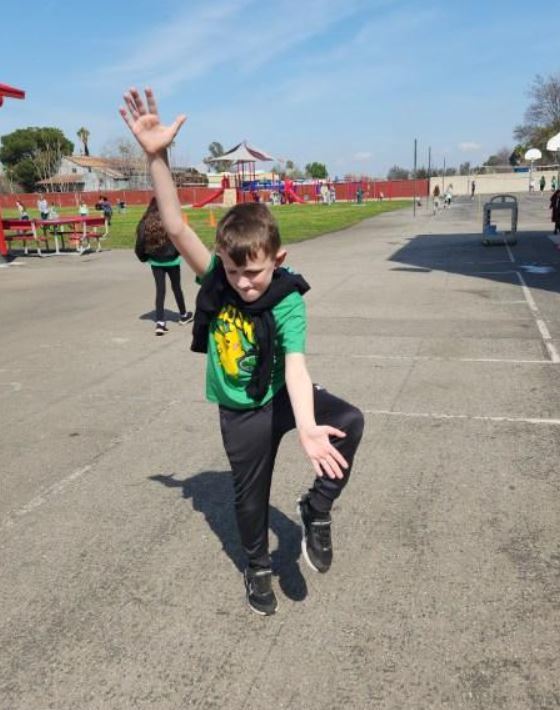 student with St. Patrick's Day outfit dancing
