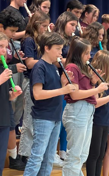 students playing the recorder on stage